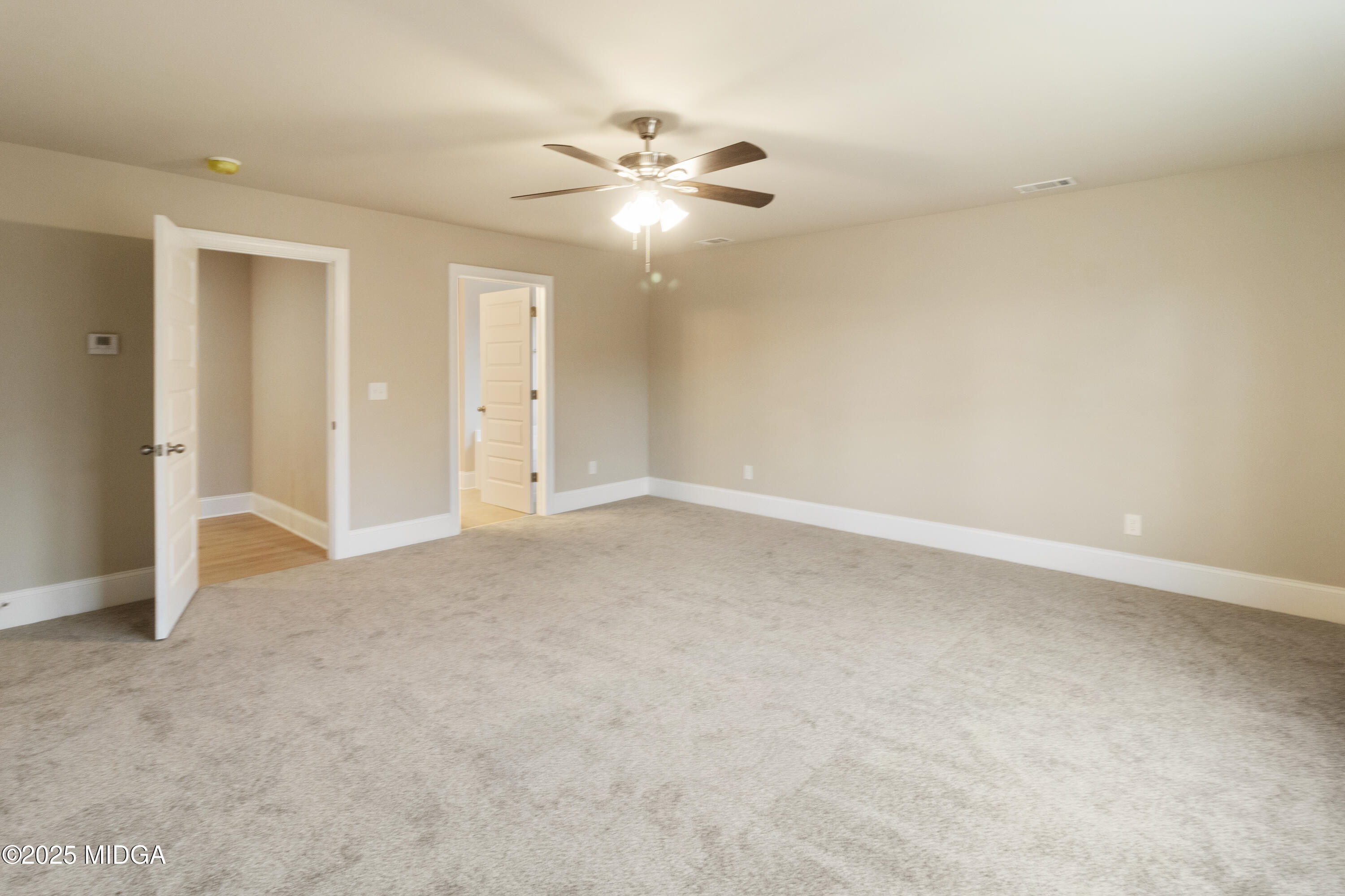 703 Giles Road Forsyth, GA 31029 - Photo 19 of 30 an empty room with a ceiling fan and window