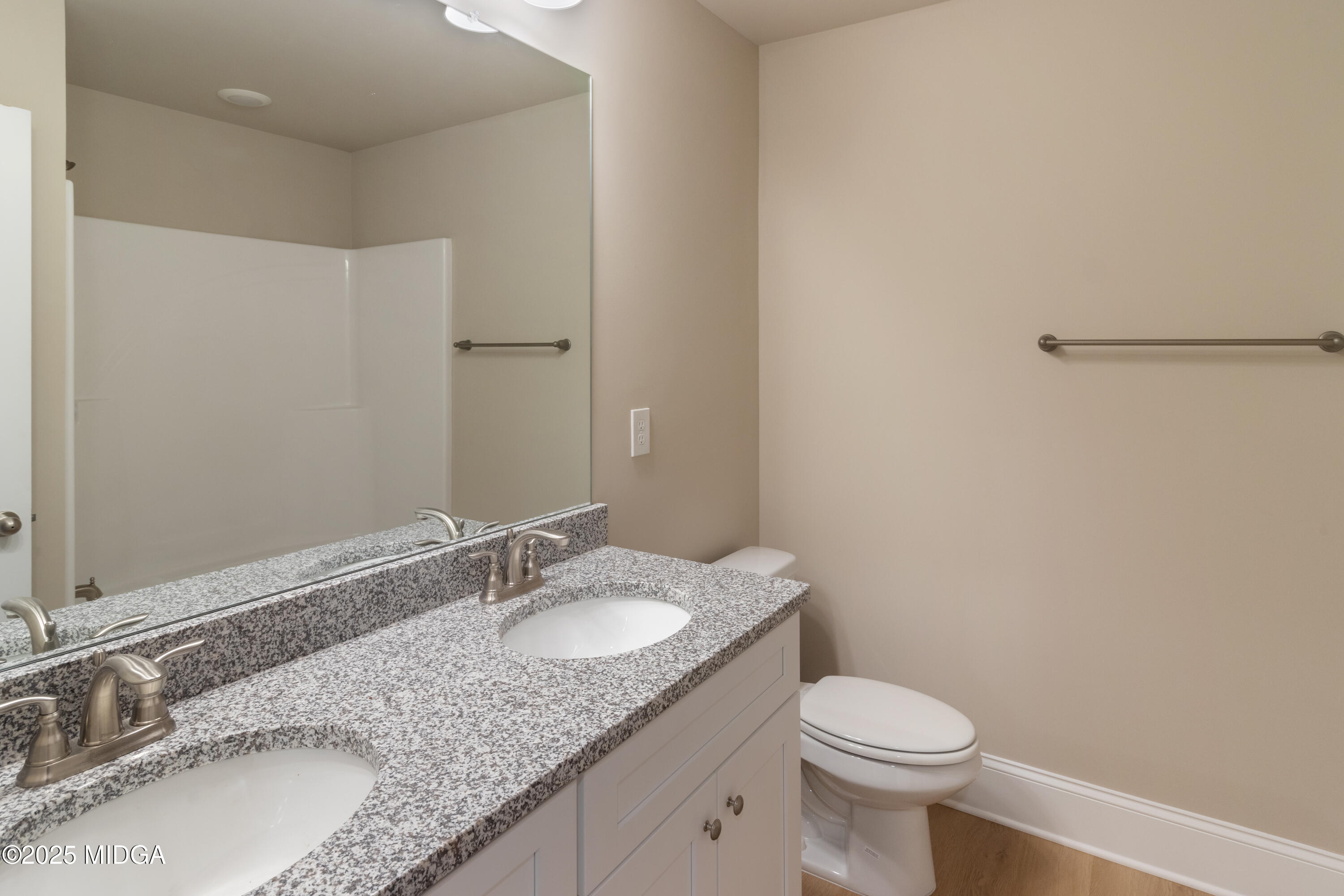 703 Giles Road Forsyth, GA 31029 - Photo 29 of 30 a bathroom with a granite countertop sink toilet and a mirror