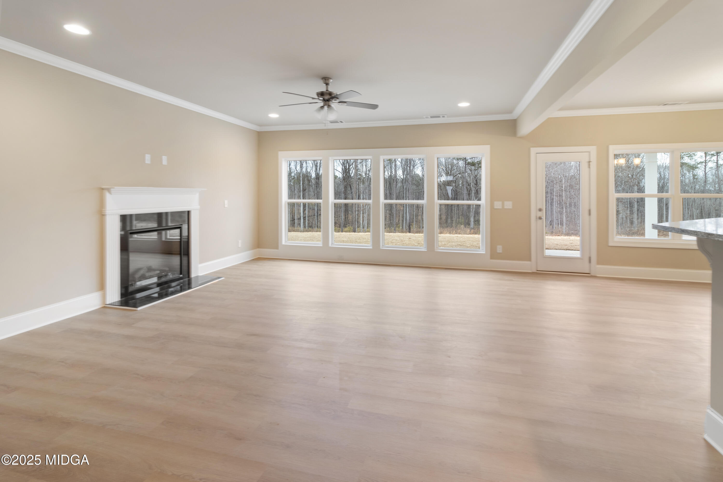 703 Giles Road Forsyth, GA 31029 - Photo 7 of 30 a view of an empty room with a window and wooden floor