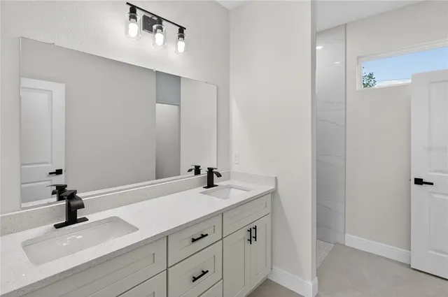 a bathroom with a sink double vanity and a mirror