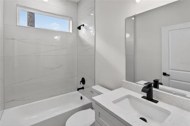 a bathroom with a sink a toilet and bathtub