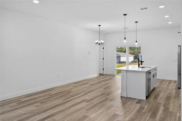 a view of a kitchen with wooden floor