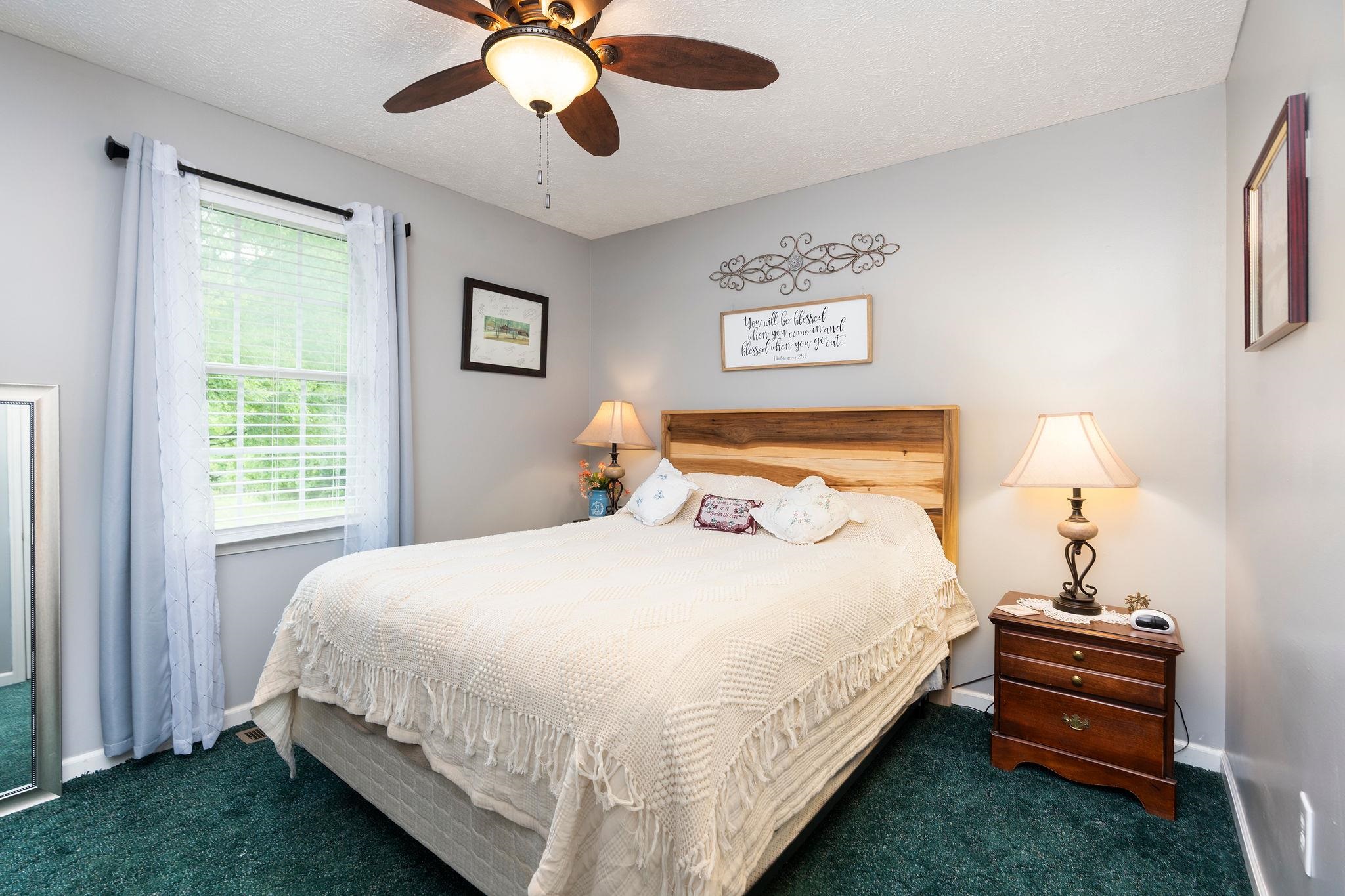 516 Estaline Valley Road Craigsville, VA 24430 - Photo 41 of 75 a bedroom with bed and a chandelier