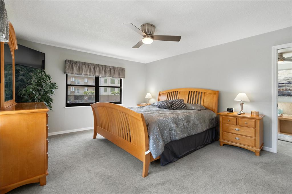 14001 Gulf Boulevard, Unit 201 Madeira Beach, FL 33708 - Photo 17 of 36 a bedroom with a bed closet and window