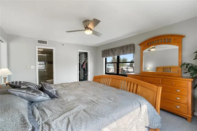 a bedroom with a large bed and a dresser