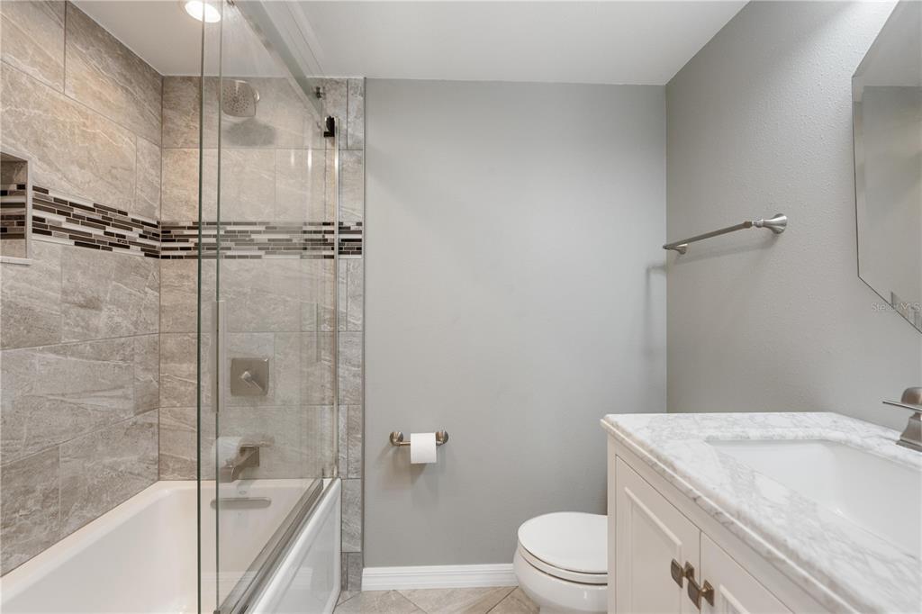 14001 Gulf Boulevard, Unit 201 Madeira Beach, FL 33708 - Photo 21 of 36 a bath room with a toilet sink and a bath tub