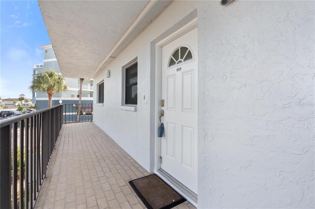 14001 Gulf Boulevard, Unit 201 Madeira Beach, FL 33708 - Photo 4 of 36 a view of a hallway with wooden floor and fence