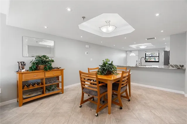 a view of a dining room with furniture and a potted plant