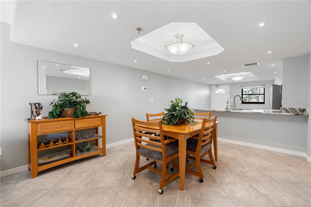 14001 Gulf Boulevard, Unit 201 Madeira Beach, FL 33708 - Photo 10 of 36 a view of a dining room with furniture and a potted plant