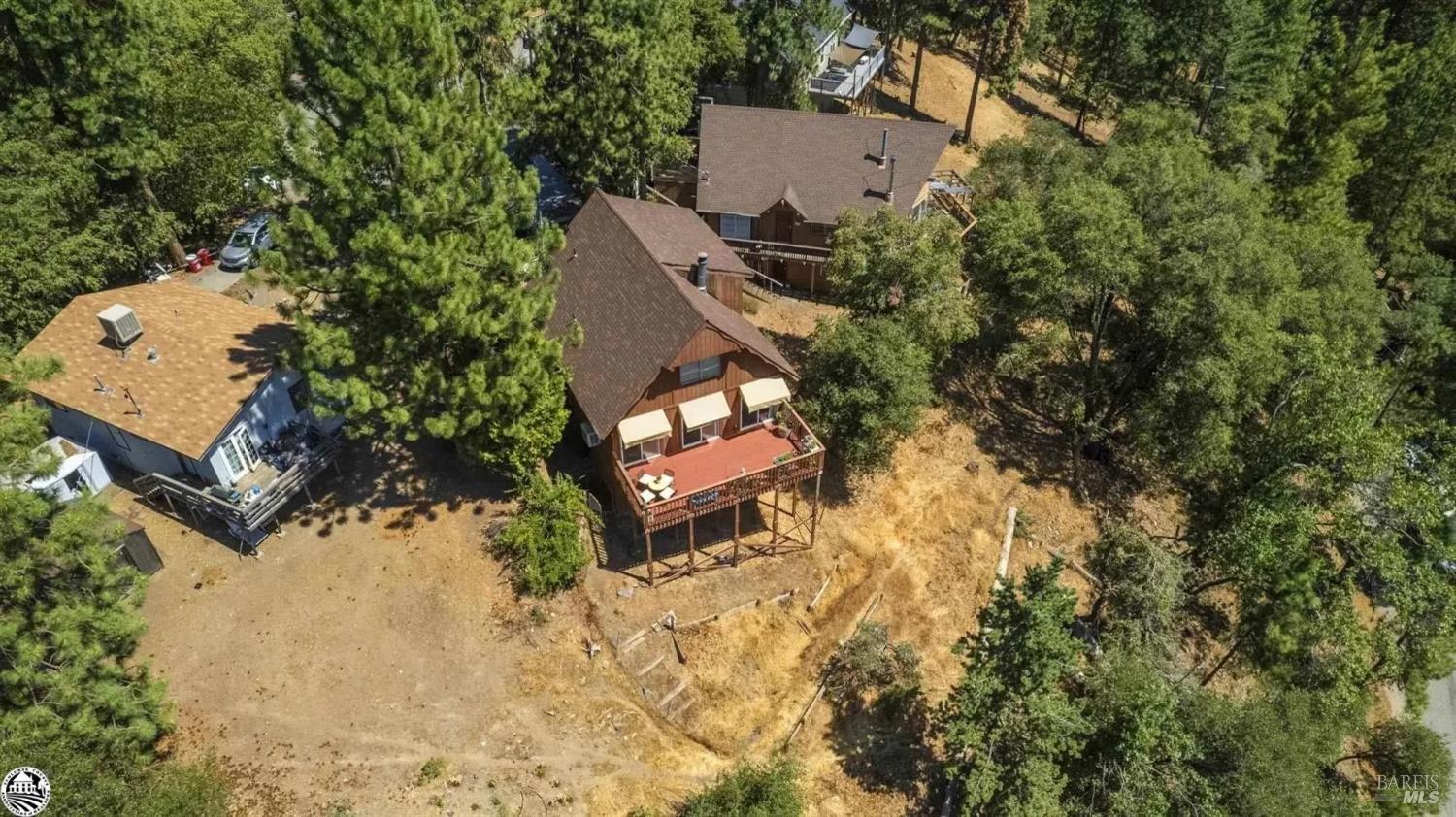 an aerial view of a house with yard