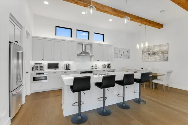 a kitchen with white cabinets and stainless steel appliances