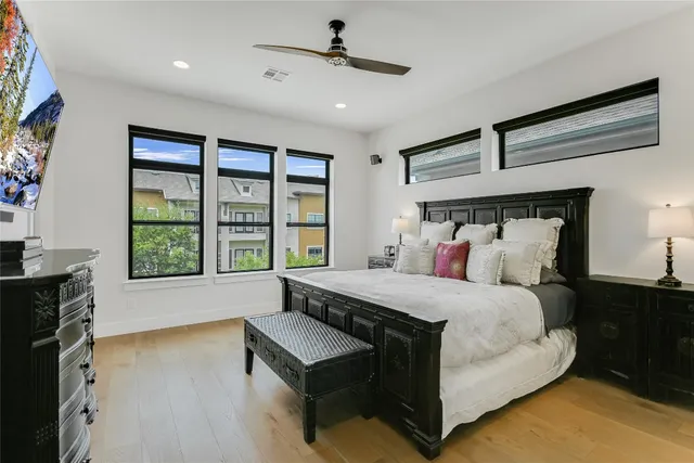 a bedroom with a bed and a large window