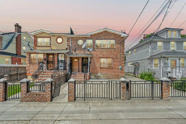 front view of a brick house with a large window