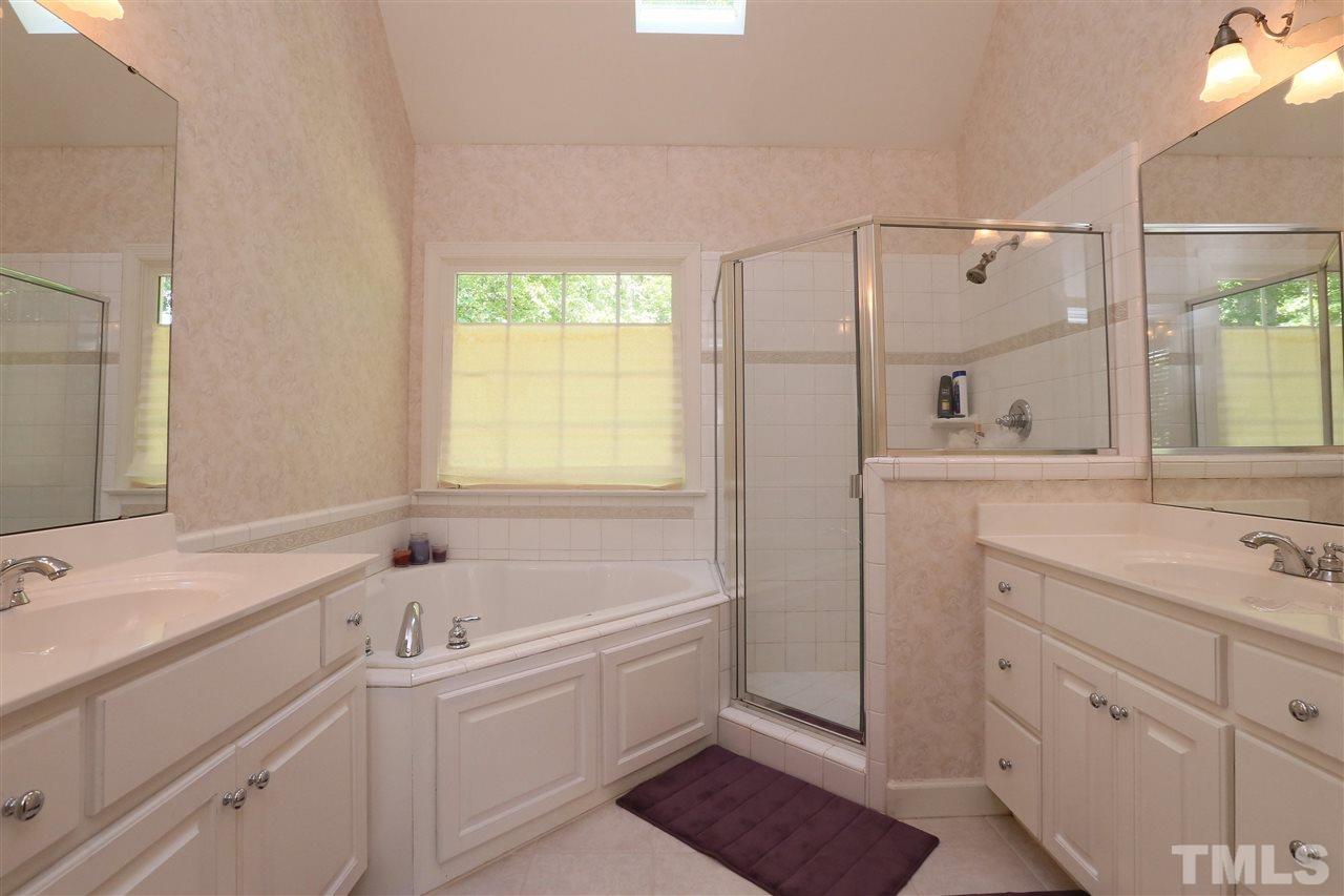 6729 Hammersmith Drive Raleigh, NC 27613 - Photo 11 of 21 a bathroom with a sink mirror and a bathtub