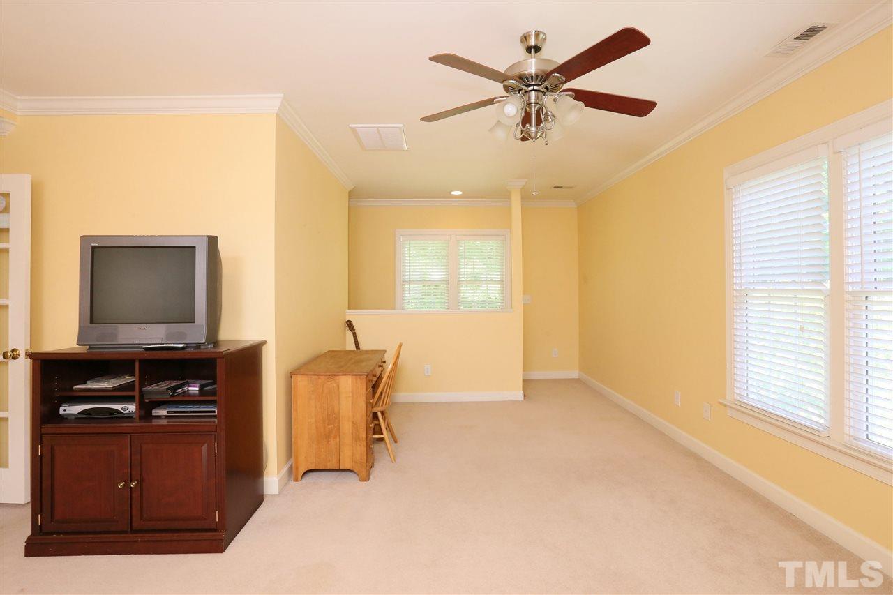 6729 Hammersmith Drive Raleigh, NC 27613 - Photo 16 of 21 a living room with furniture and a flat screen tv