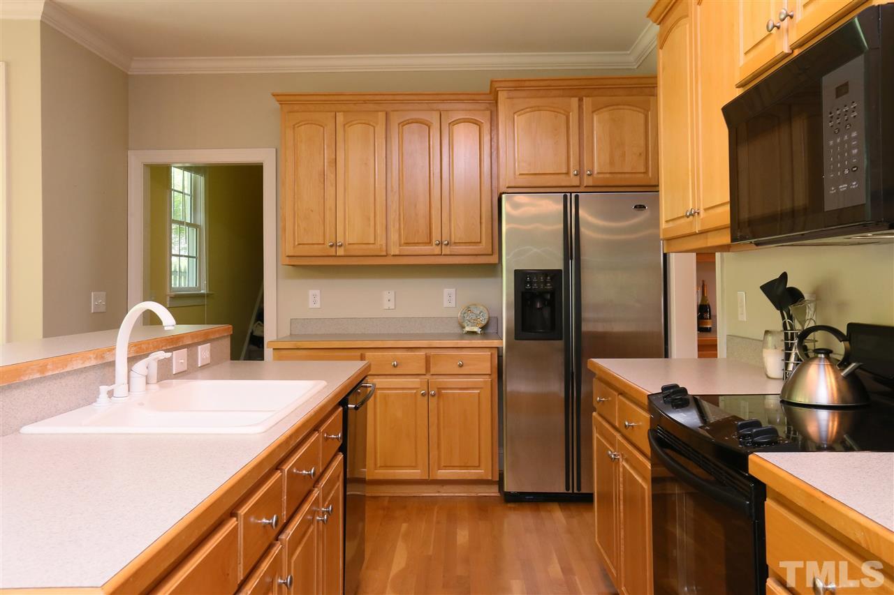 6729 Hammersmith Drive Raleigh, NC 27613 - Photo 8 of 21 a kitchen with stainless steel appliances granite countertop a sink stove and refrigerator