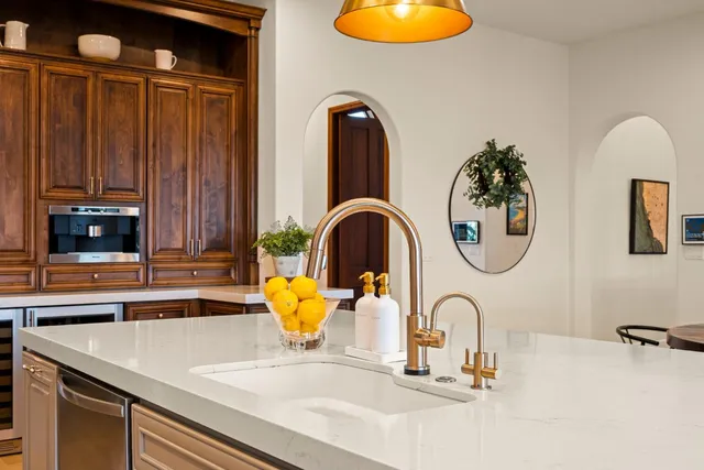 a kitchen with a refrigerator and a sink