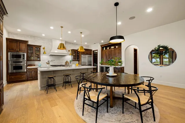 a view of a dining room with furniture and wooden floor