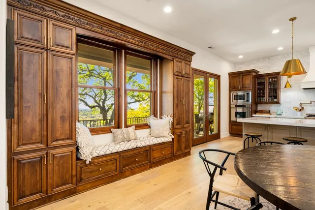 a view of a dining room with furniture and chandelier
