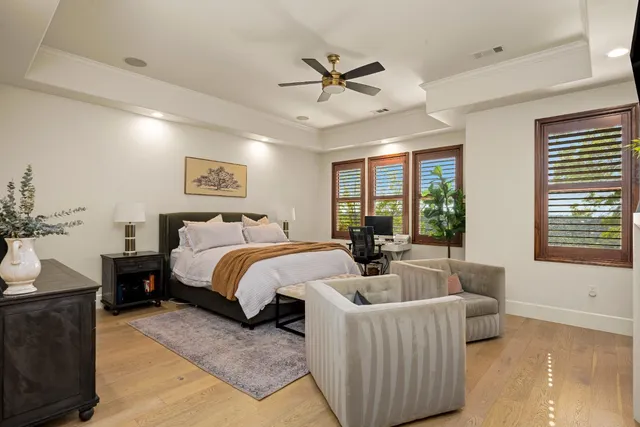 a bedroom with a bed gym equipment and a large window