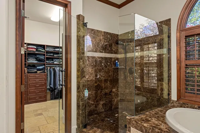 a bathroom with a glass shower door