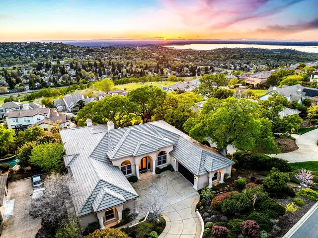an aerial view of residential houses with city view