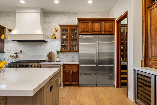 a kitchen with a stove a sink and a refrigerator