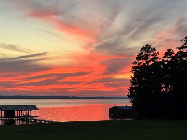 a view of a house with swimming pool and yard