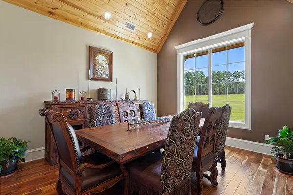 a bedroom with a bed and a flat tv screen on dresser