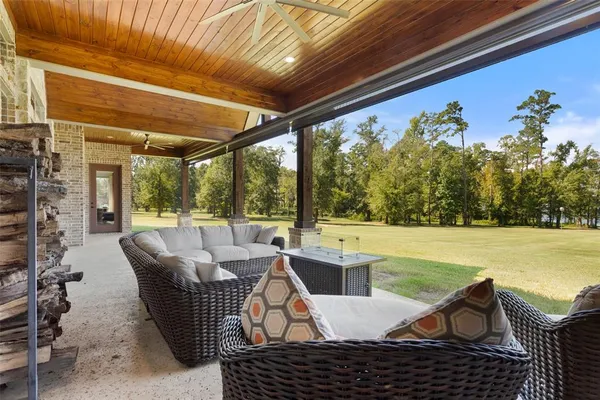 a view of a patio with table and chairs under an umbrella