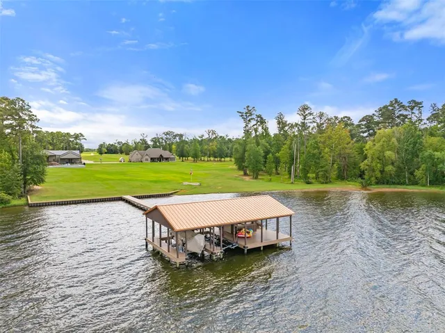 a view of a house with a yard from a lake view