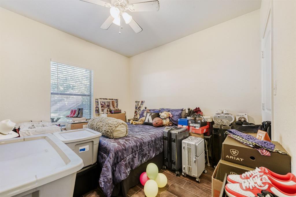 6525 Greenway Road Fort Worth, TX 76116 - Photo 26 of 29 a bedroom with furniture and a chandelier