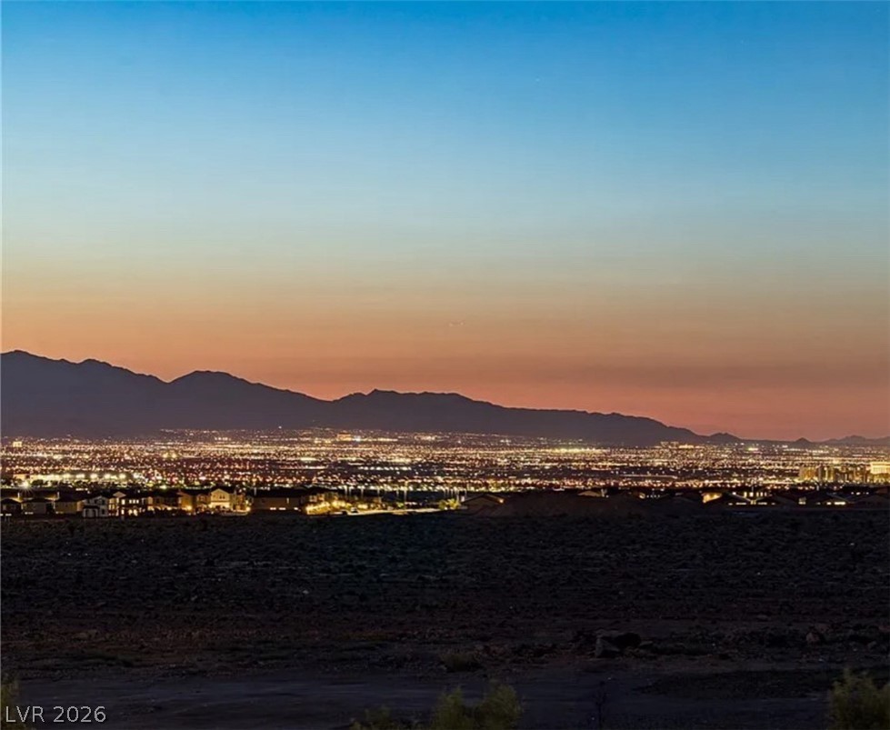 3338 Esker Rdg Avenue Henderson, NV 89044 - Photo 1 of 70 Dusk looking over SW Valley(Southern Highlands, Enterprise, Insperada) from Main Living area balcony.