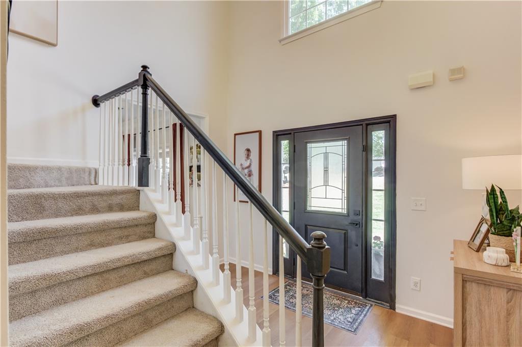 2310 Olde Hickory Place Monroe, GA 30656 - Photo 16 of 46 a view of staircase with lots of frames on wall and a potted plant