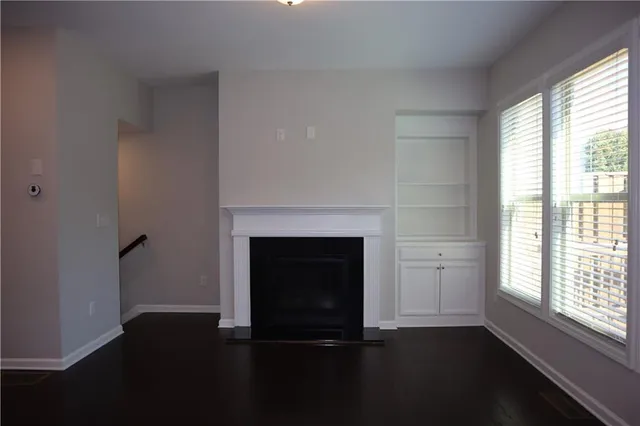 a living room with a fireplace and a window