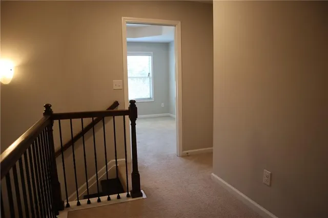 a view of a staircase with wooden floor and a window