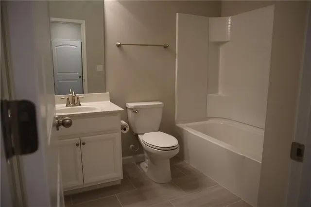 a white toilet sitting next to a bath tub