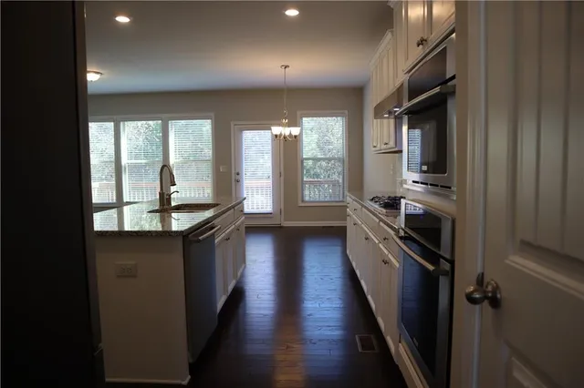 a kitchen with counter top space and stainless steel appliances