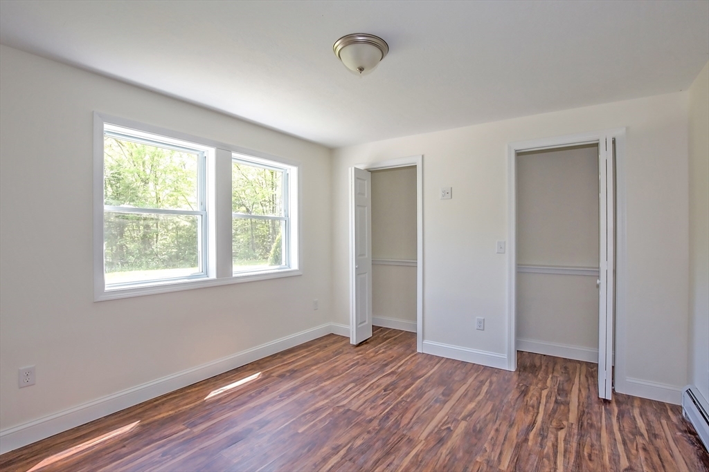 165 Sandisfield Road Sandisfield, MA 01255 - Photo 6 of 37 a view of an empty room with wooden floor and a window