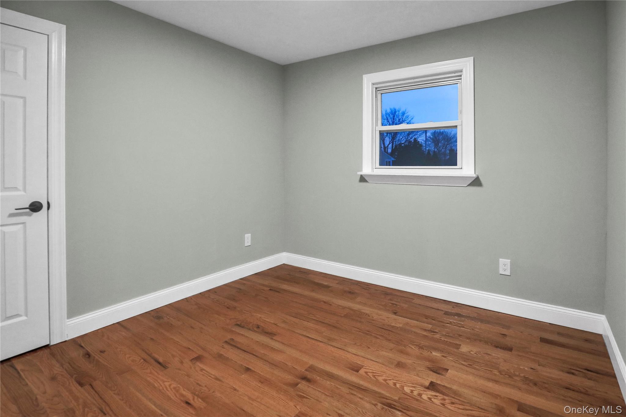 45 Colony Lane Syosset, NY 11791 - Photo 15 of 23 a view of an empty room with wooden floor and a window
