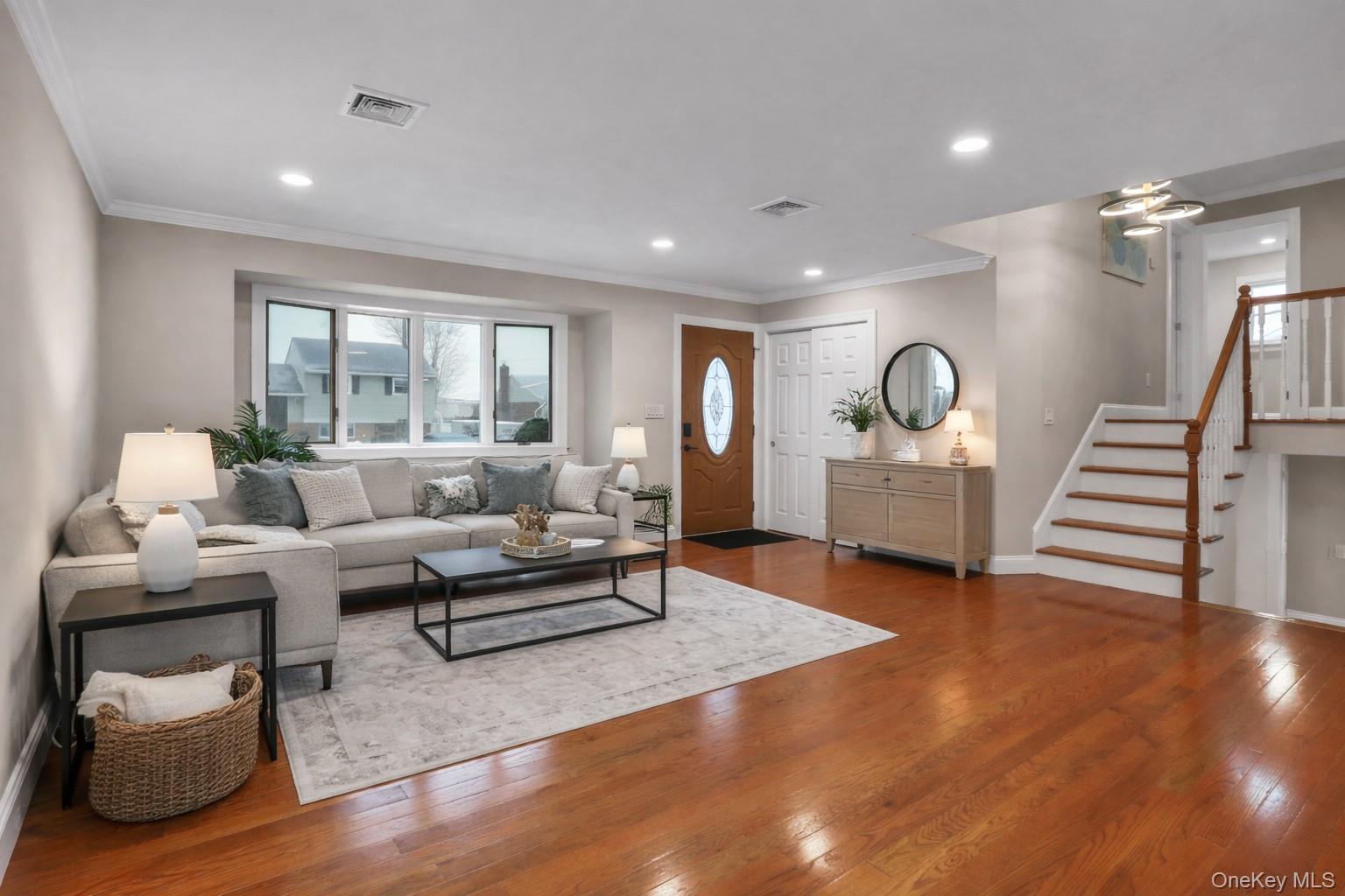 45 Colony Lane Syosset, NY 11791 - Photo 2 of 23 a living room with furniture and a wooden floor
