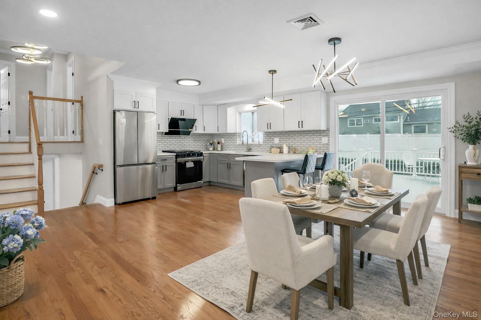 45 Colony Lane Syosset, NY 11791 - Photo 3 of 23 a dining room with stainless steel appliances kitchen island granite countertop a table chairs and a refrigerator