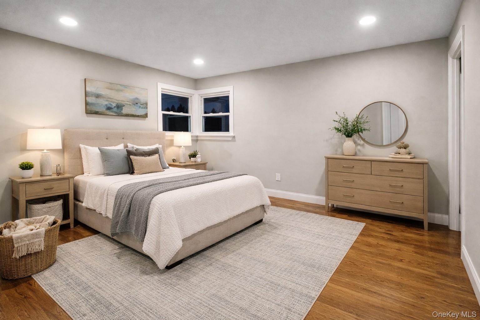 45 Colony Lane Syosset, NY 11791 - Photo 9 of 23 a bedroom with a large bed and a chandelier