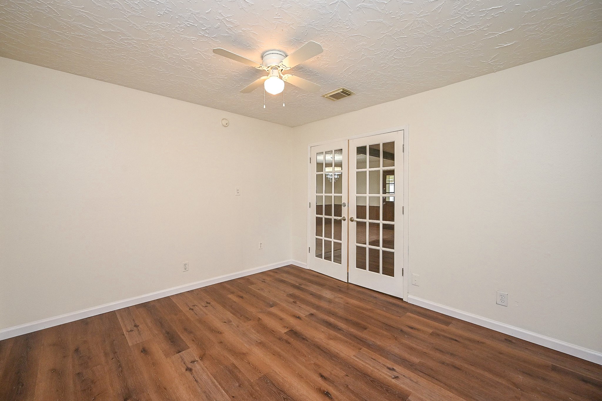 23814 Spring Gum Drive Spring, TX 77373 - Photo 3 of 21 a view of empty room with wooden floor and fan