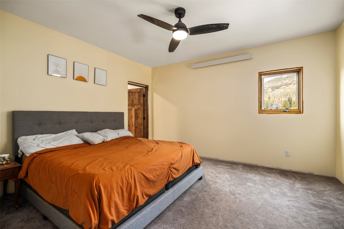 29195 River Drive Clark, CO 80428 - Photo 14 of 36 a bedroom with a bed and a painting on the wall