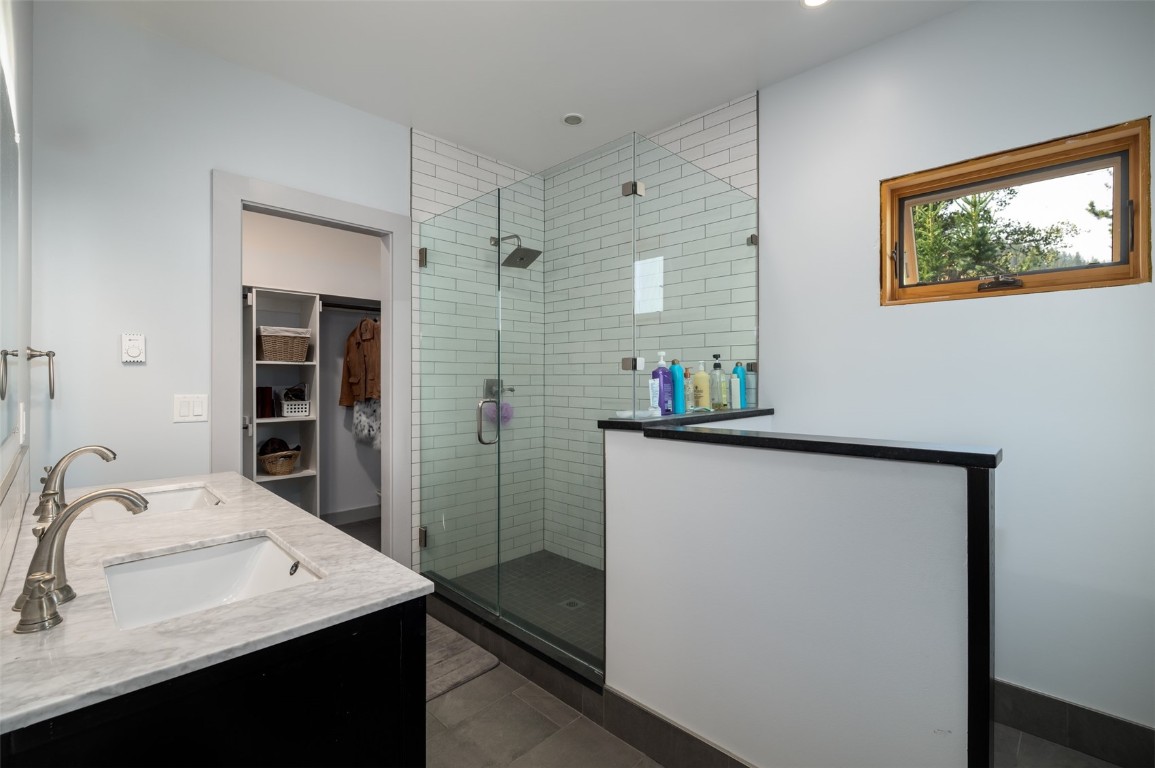 29195 River Drive Clark, CO 80428 - Photo 16 of 36 a bathroom with a sink a mirror and a shower