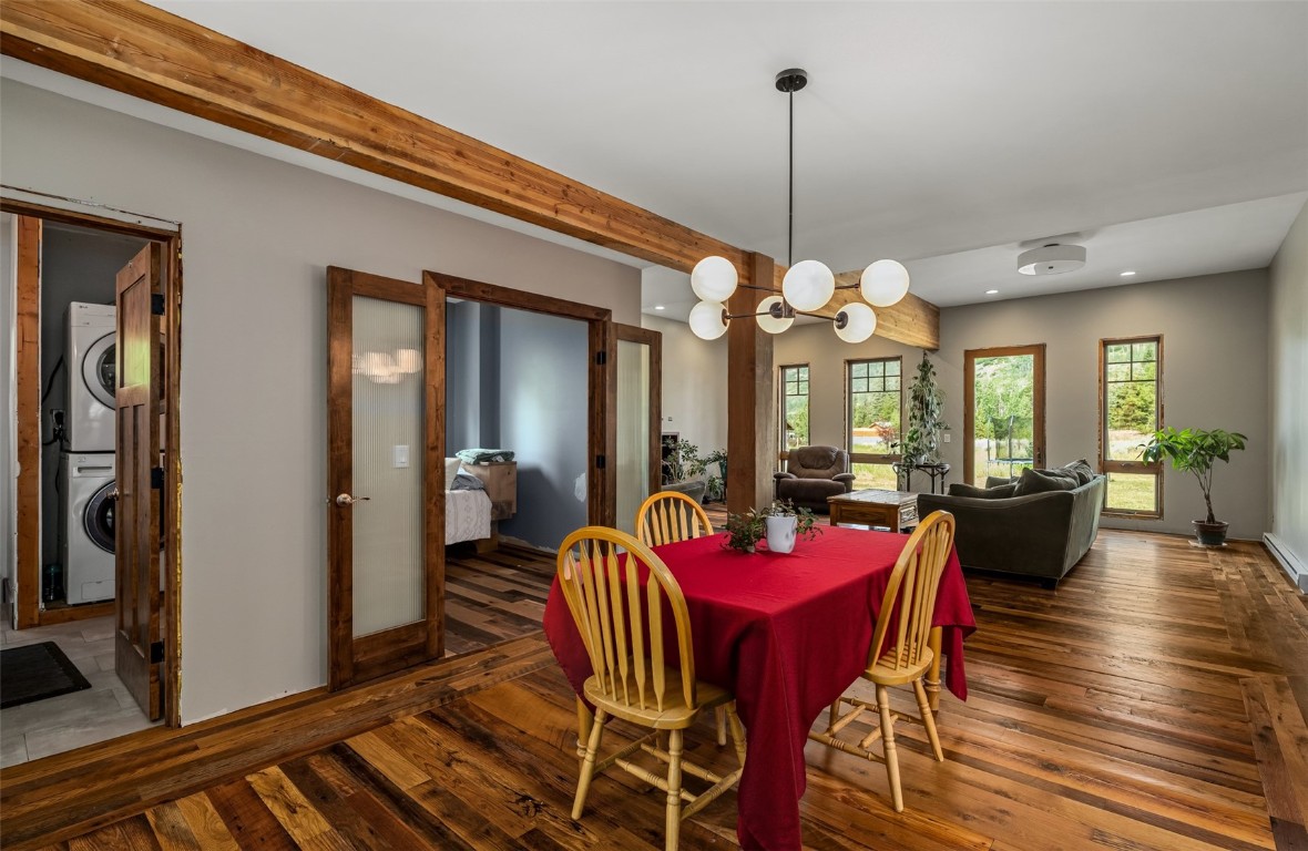 29195 River Drive Clark, CO 80428 - Photo 8 of 36 a view of a dining room and livingroom with furniture wooden floor a chandelier