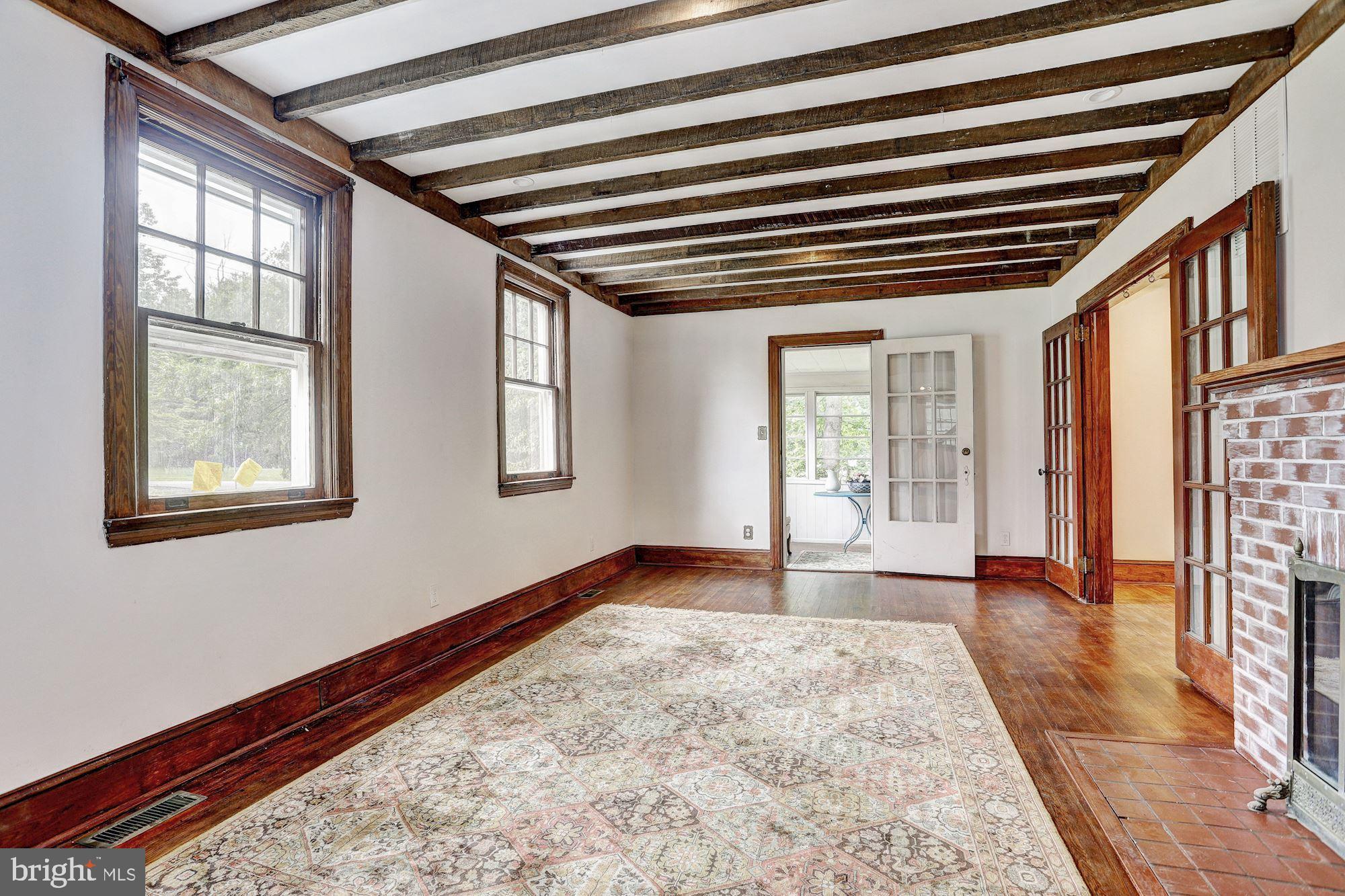 11858 Frederick Road Ellicott City, MD 21042 - Photo 3 of 35 Living room with exposed new wood beam ceiling