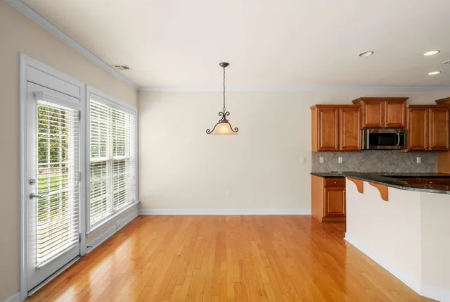 a kitchen with stainless steel appliances granite countertop a refrigerator a sink and a stove with granite countertops