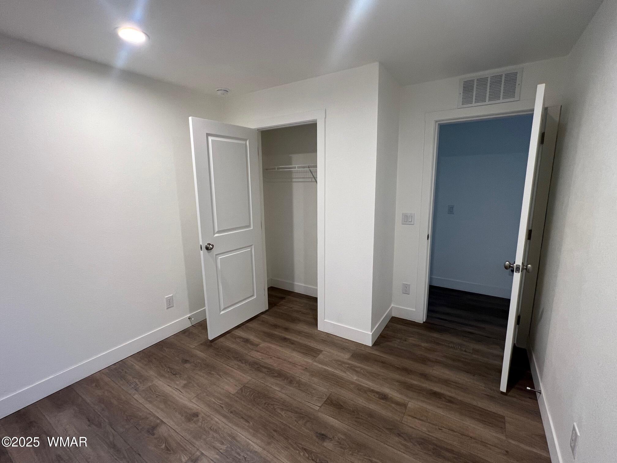 4129 Apache Road Snowflake, AZ 85937 - Photo 20 of 48 an empty room with wooden floor and closet